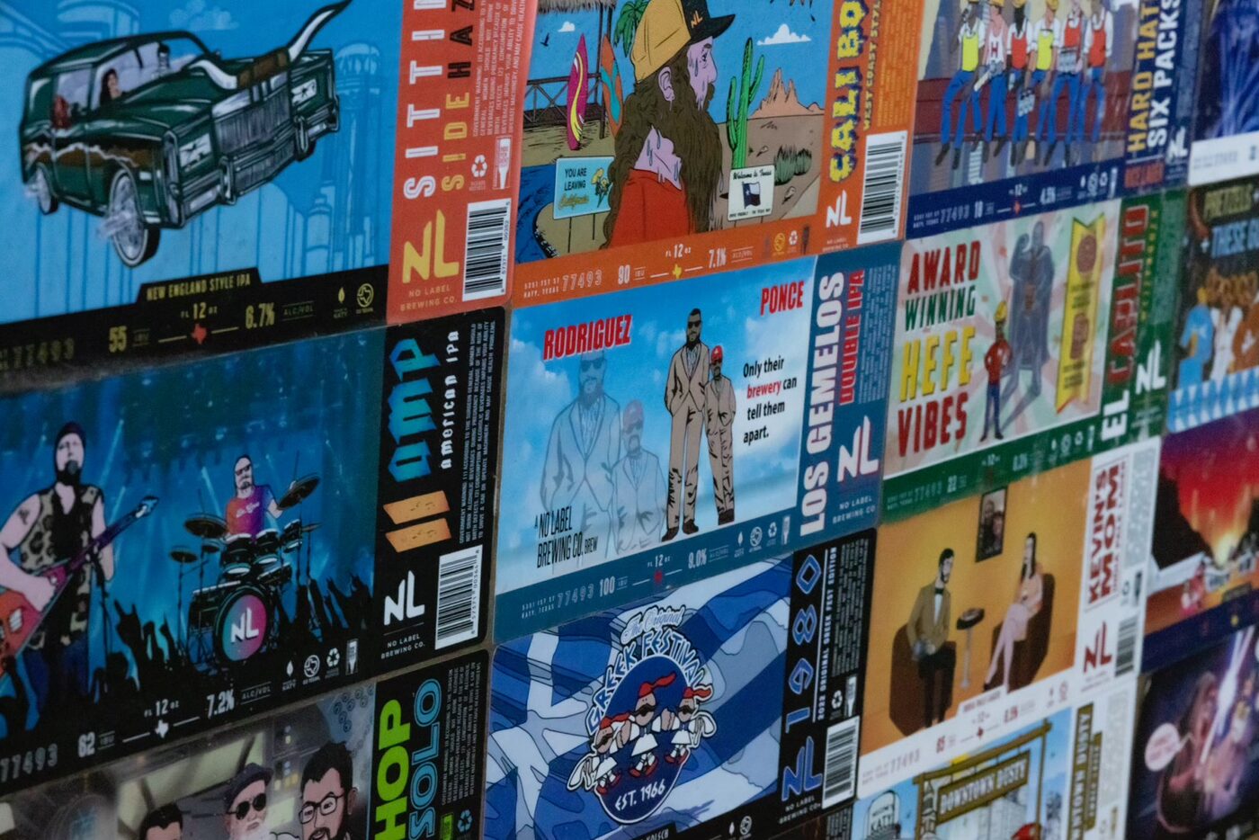 A wall of colorful No Label Brewing can labels