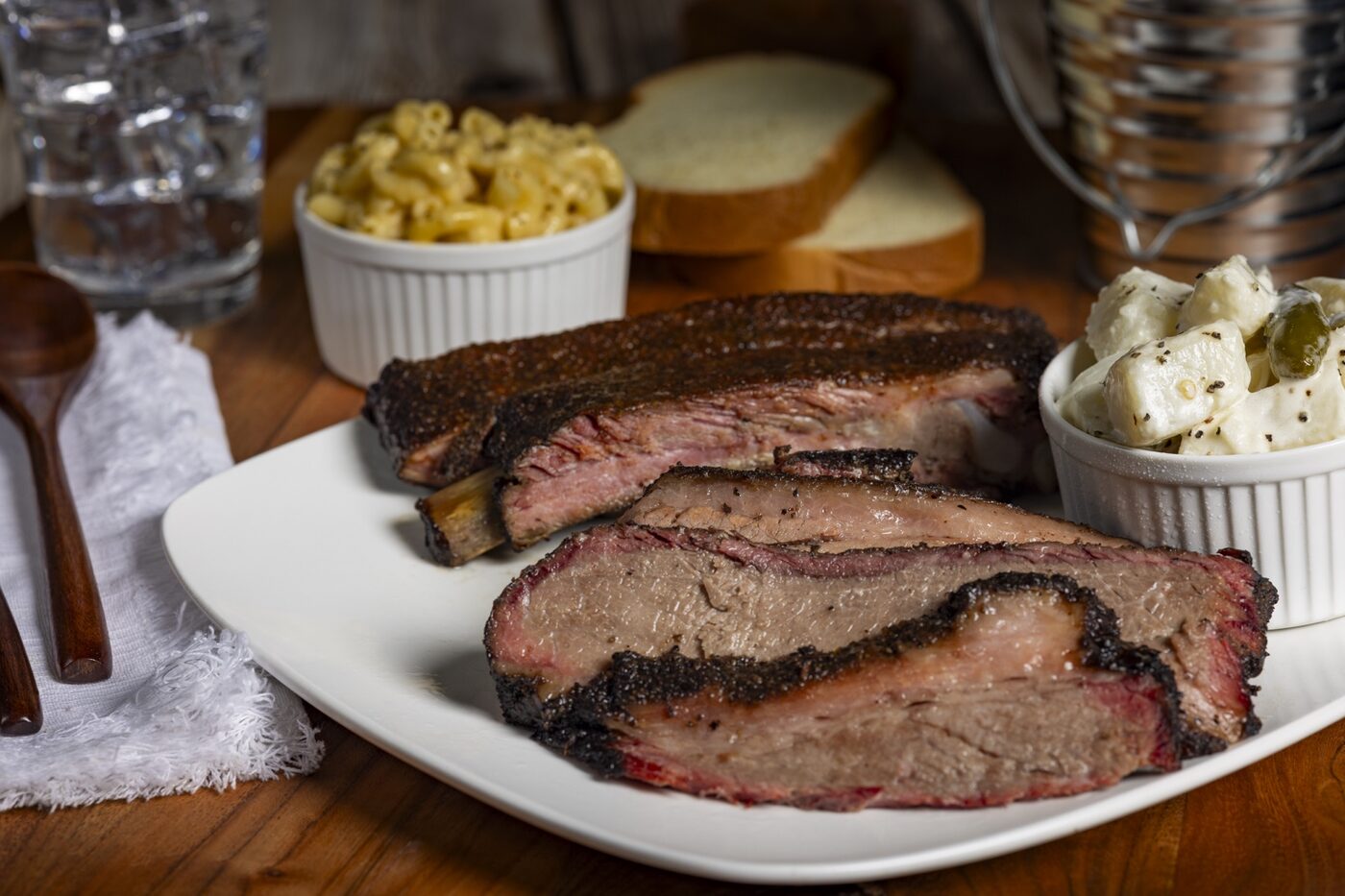Uprise BBQ brisket plate with sides, styled and photographed for the menu launch